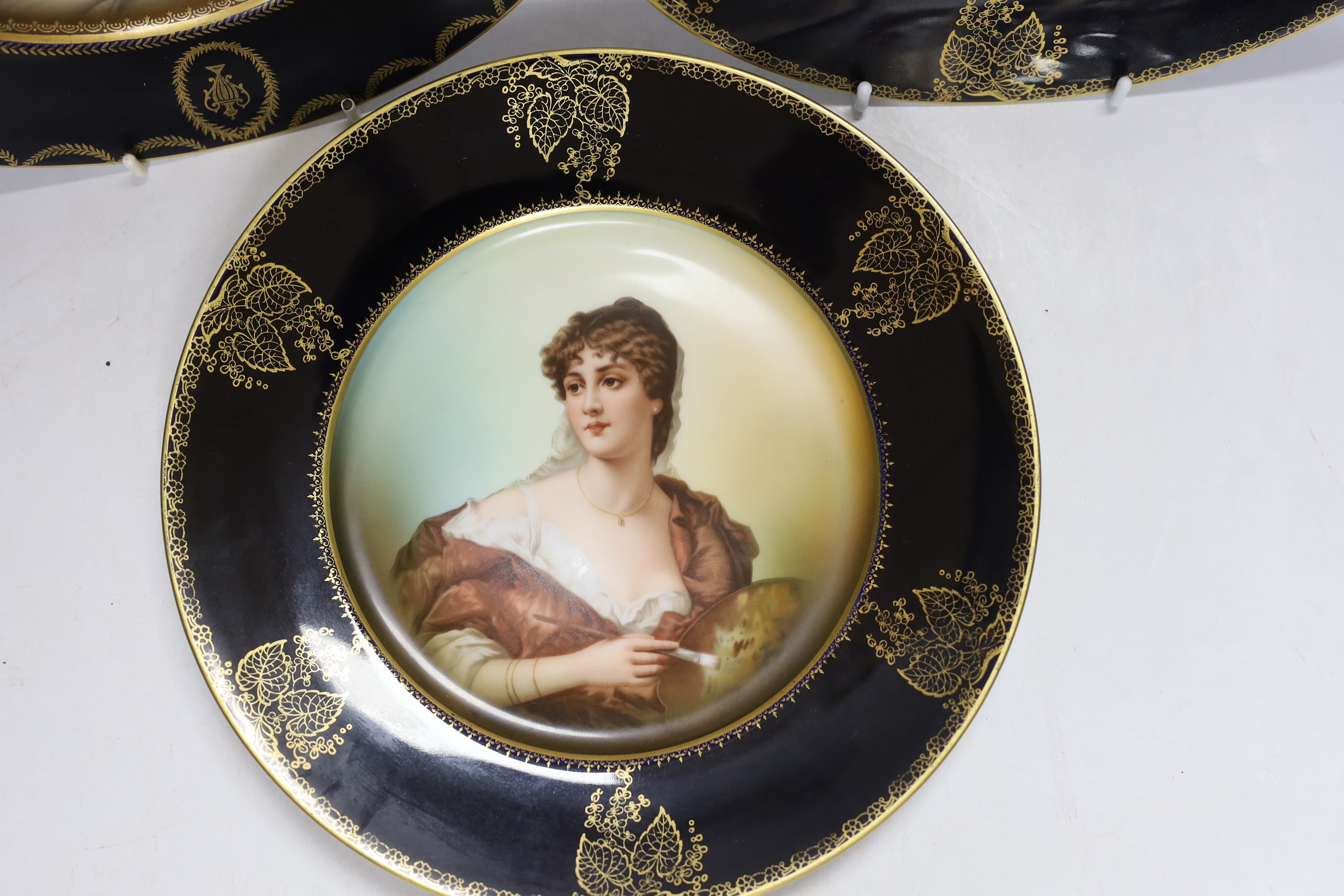 A set of three Rosenthal porcelain cabinet plates, decorated with classical females emblematic of the arts and music, 25.5cm